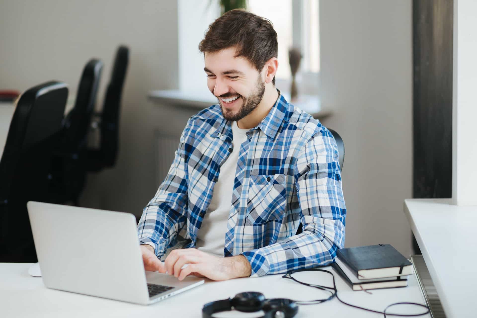 A stock image of a man working on a MacBook.