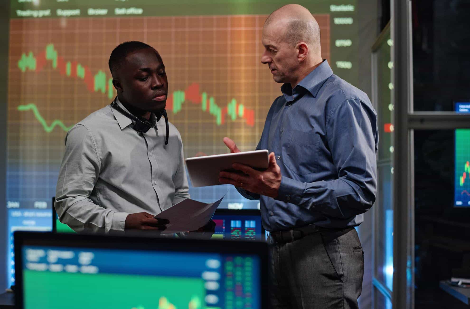 Two men doing stock trading in the UAE.