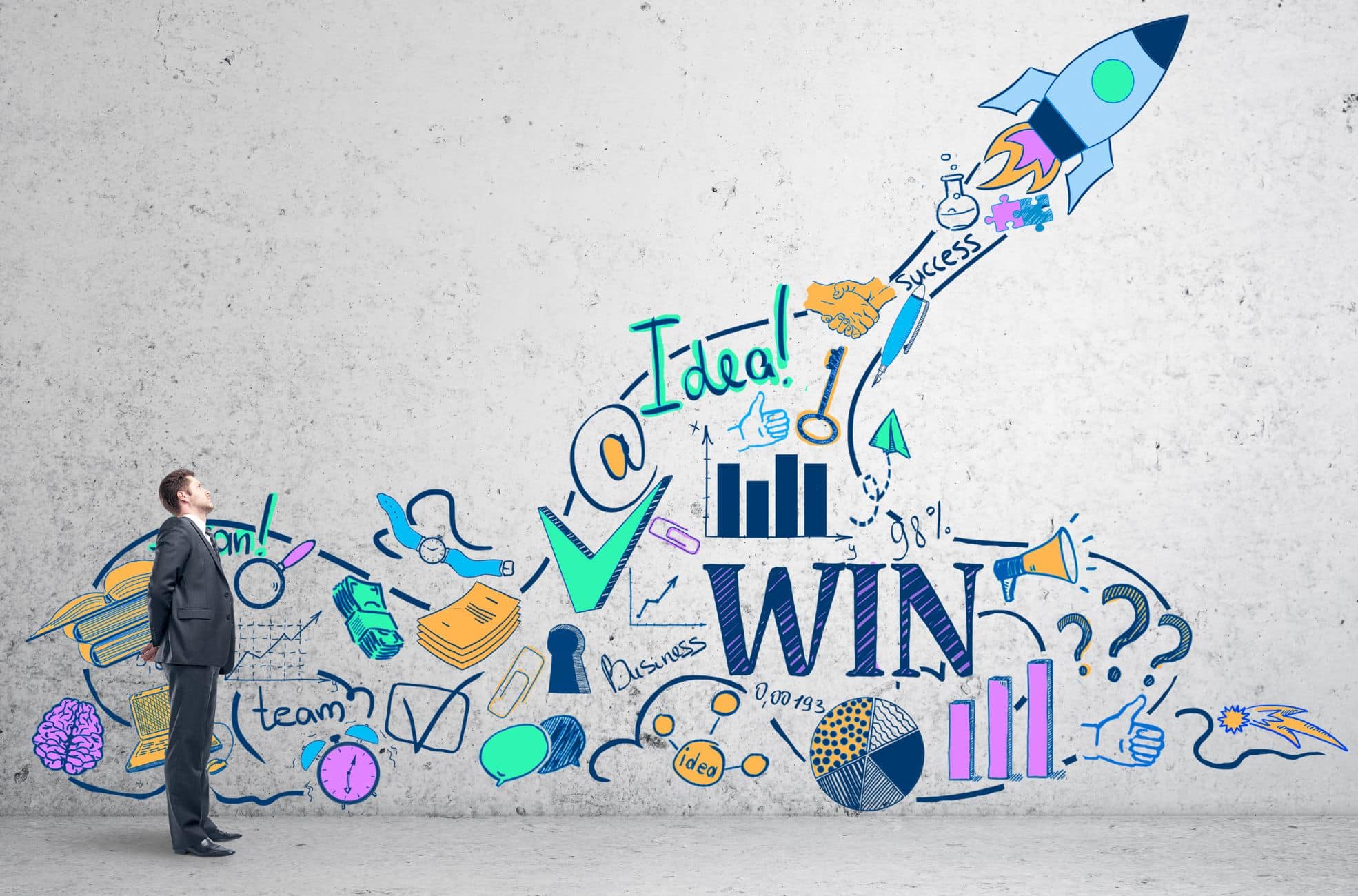 Rocket And XDrawings On A Wall With Male Entrepreneur