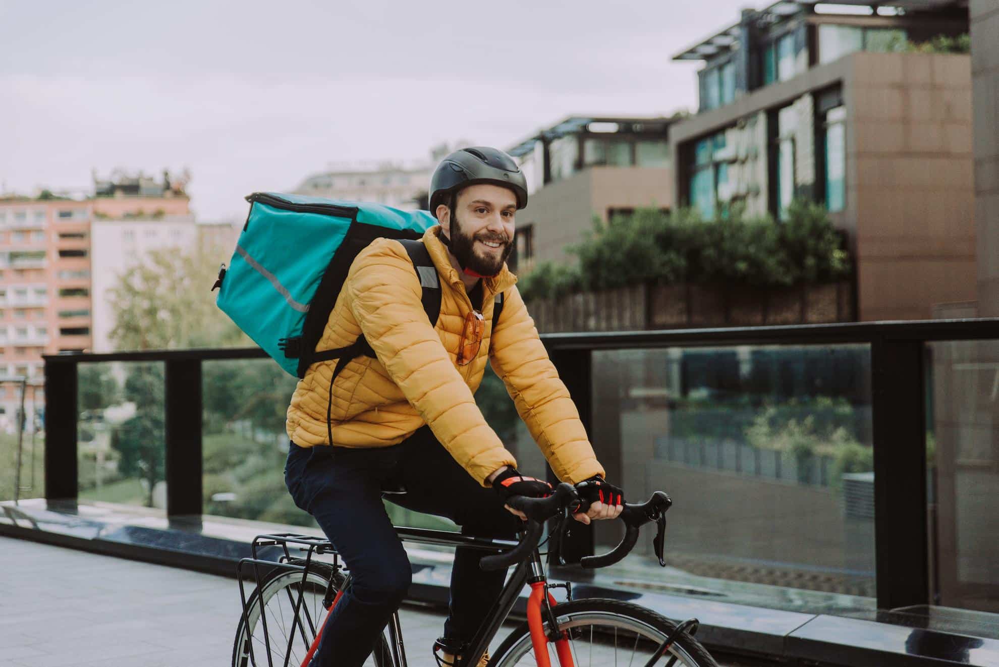 A delivery rider for a cloud kitchen in Dubai delivering an order.