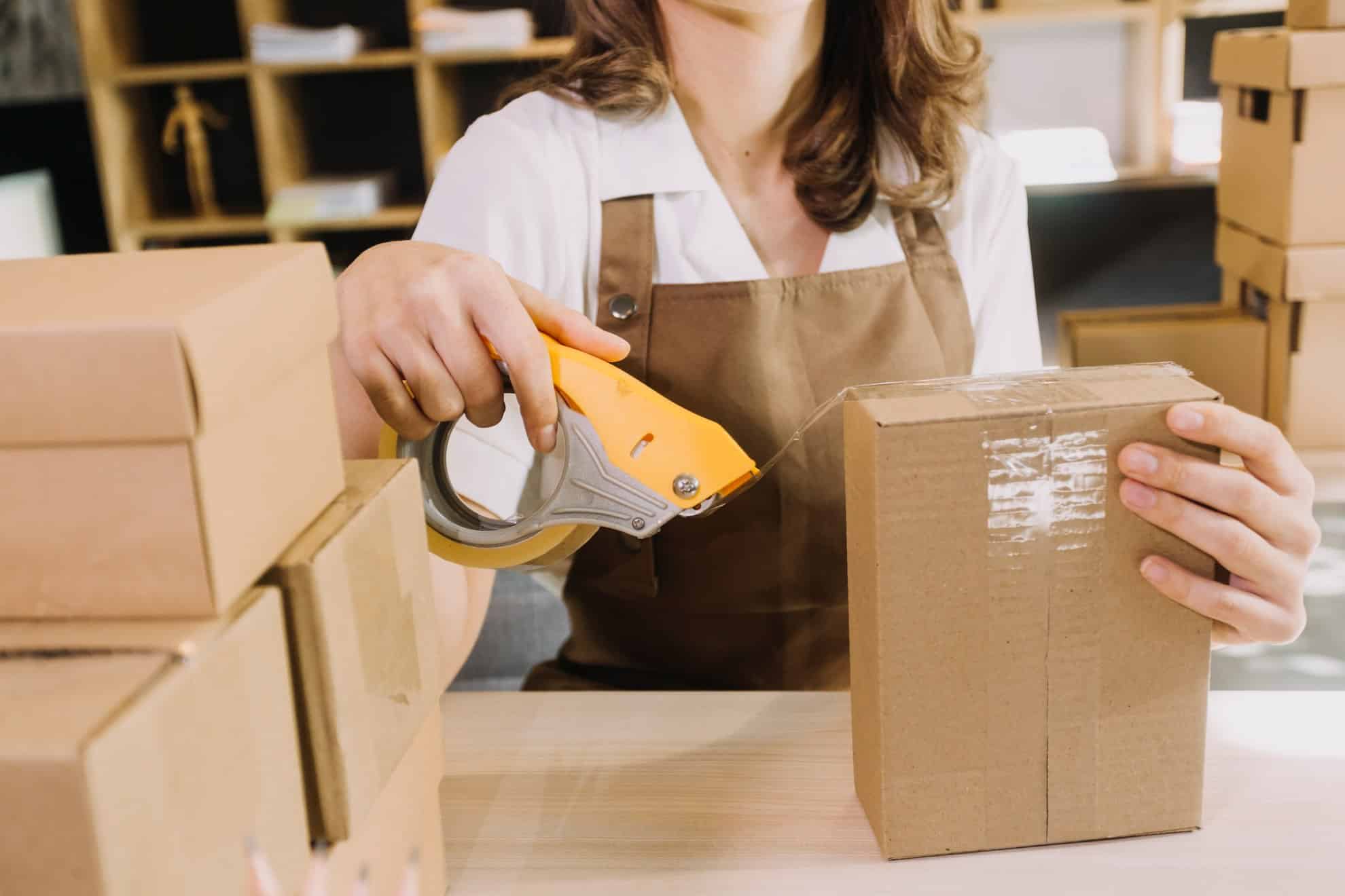 A picture of someone packaging a box for their dropshipping business.
