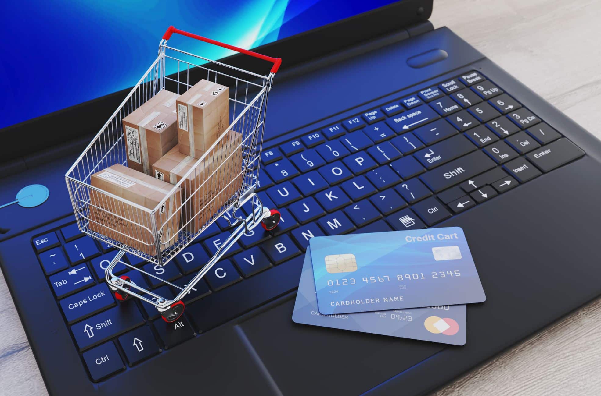 E-commerce Business Shown By Laptop, Credit Cards And Shopping Trolley