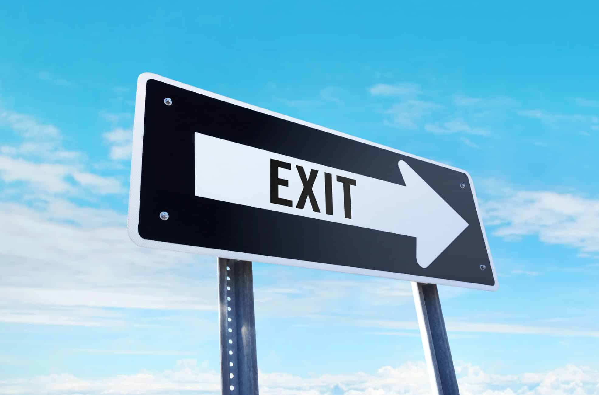 Exit Sign Against Blue Sky