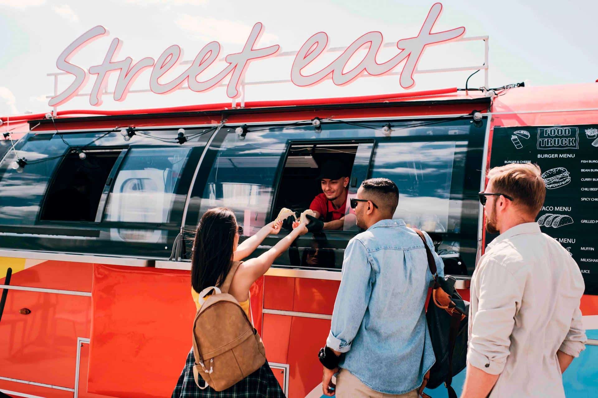 Street food truck called 'Street Eat' with 3 customers.