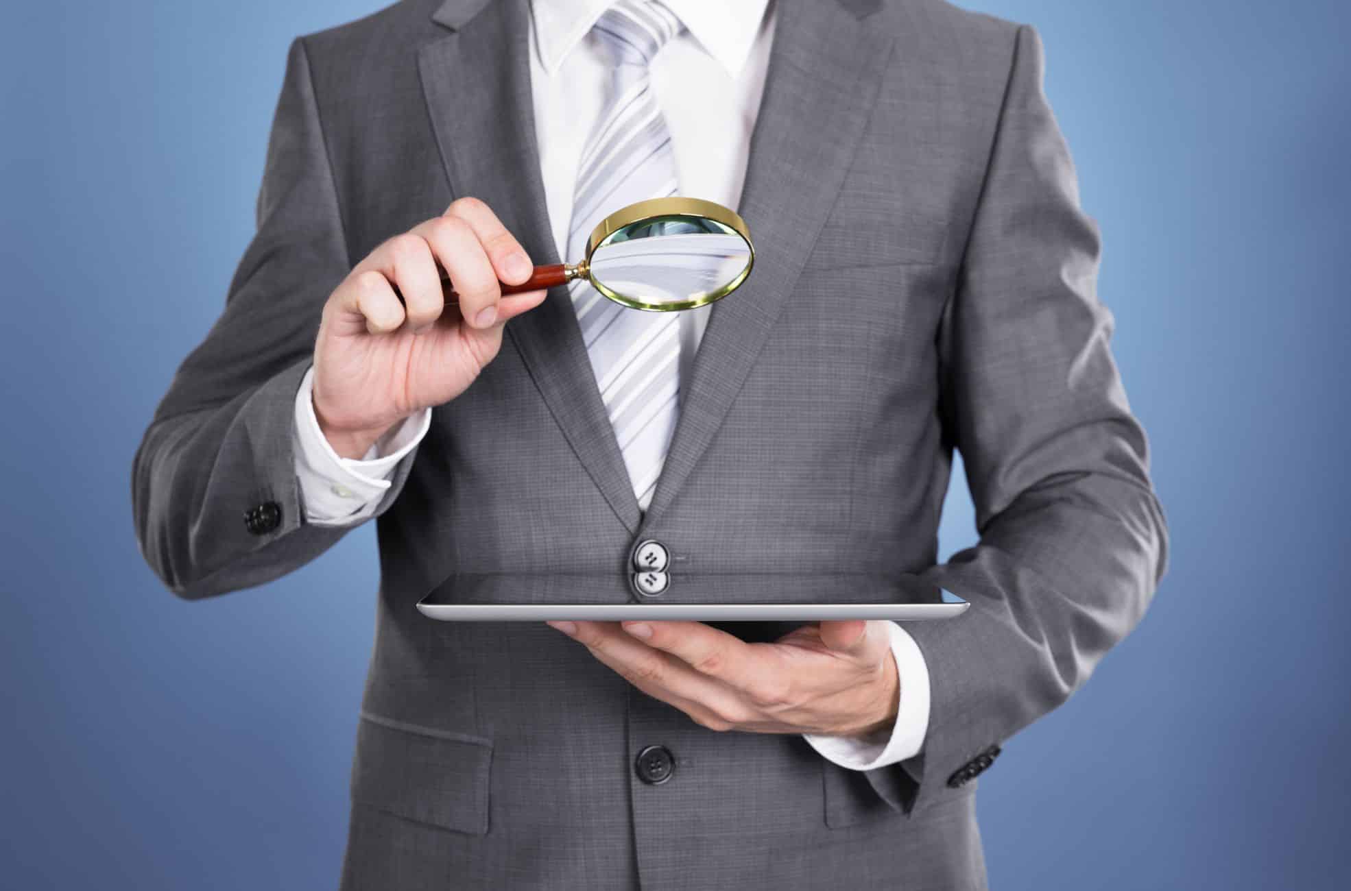 Auditor With Audit Tablet And Magnifying Glass