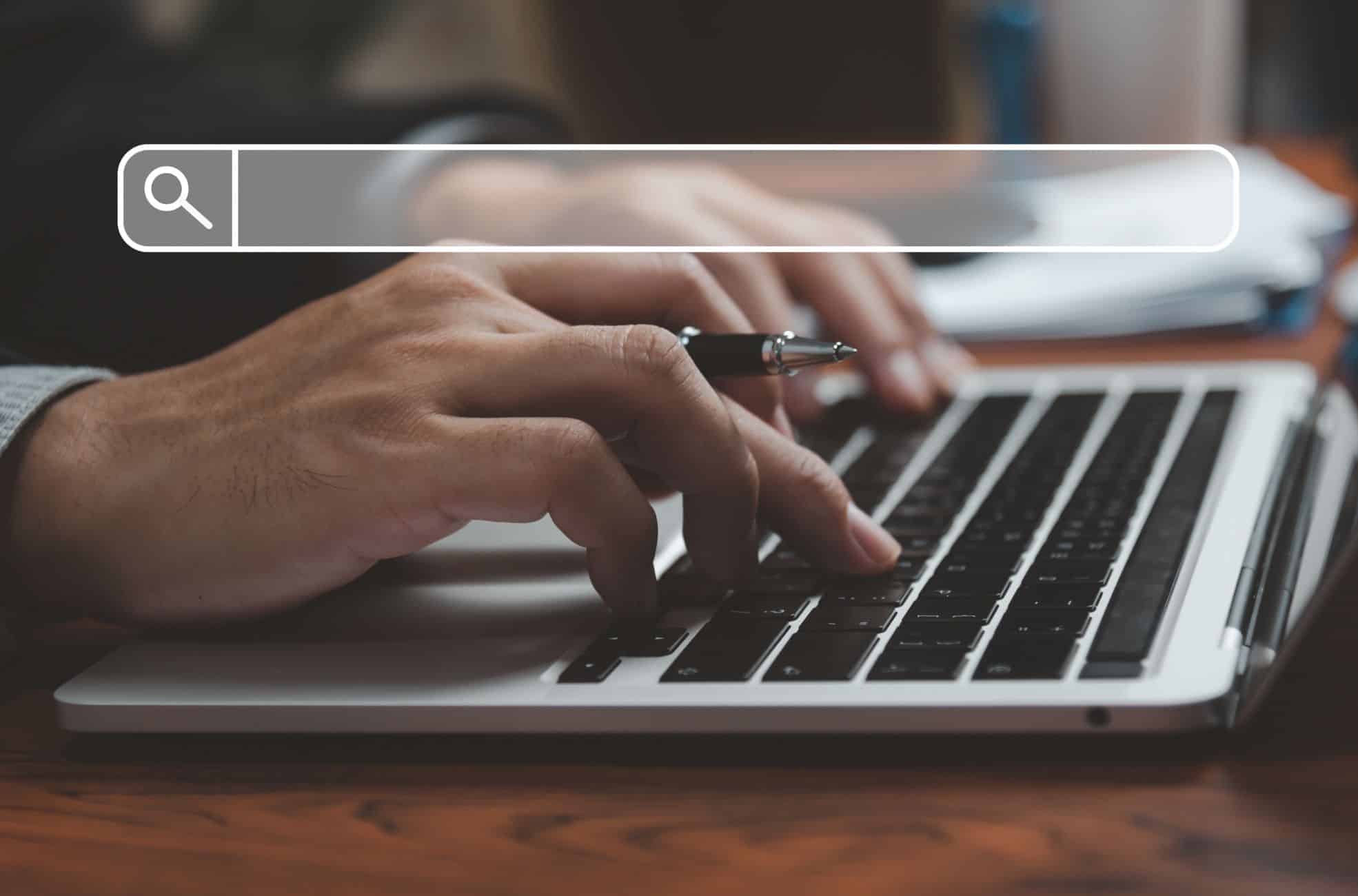 Man Using Laptop For Website Research