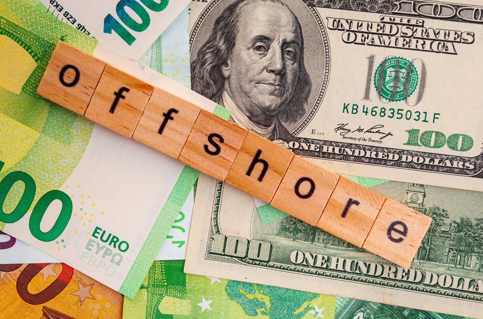 Money With Wooden Squares Spelling "Offshore"
