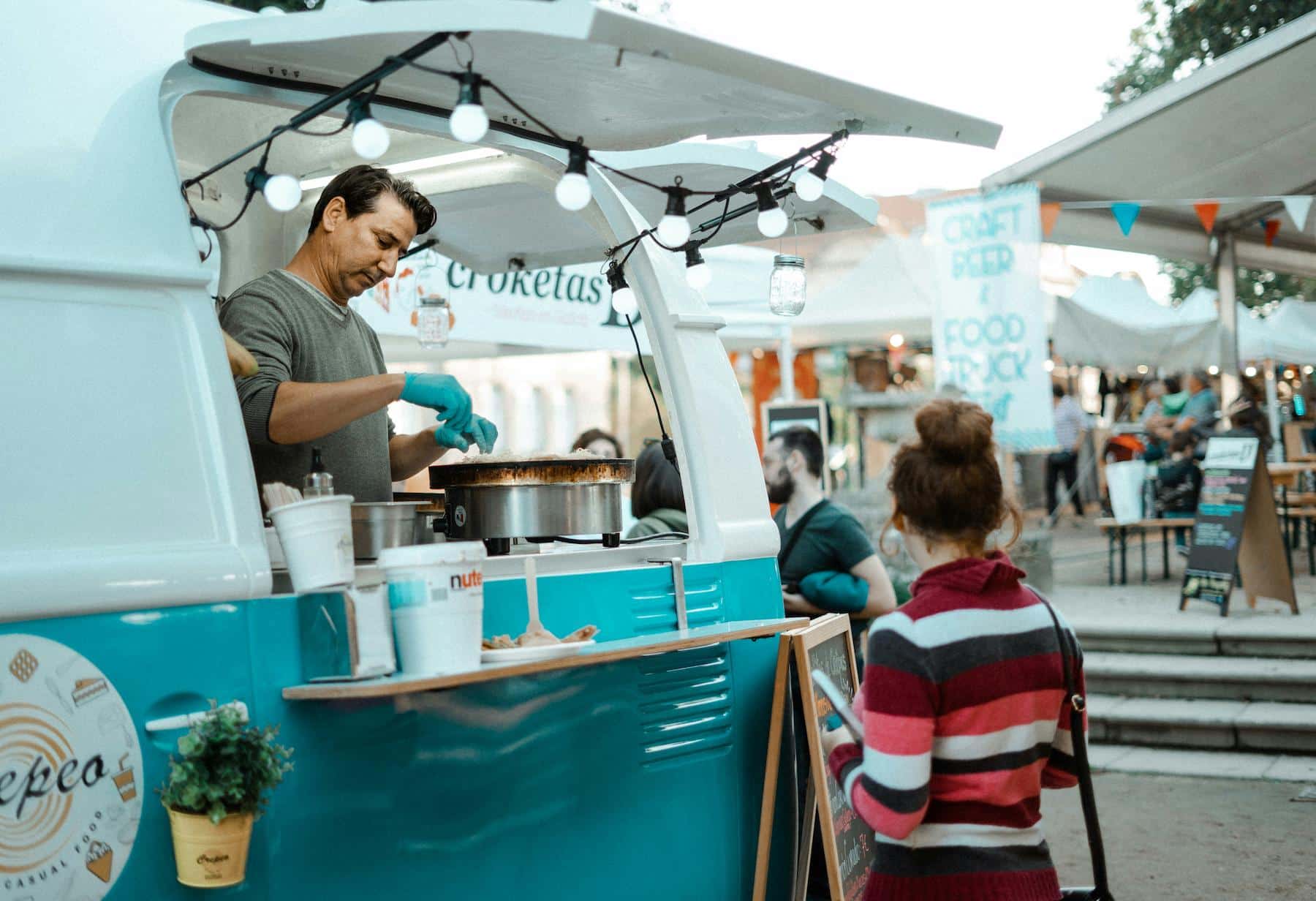 A man serving food out of his food truck in Dubai.