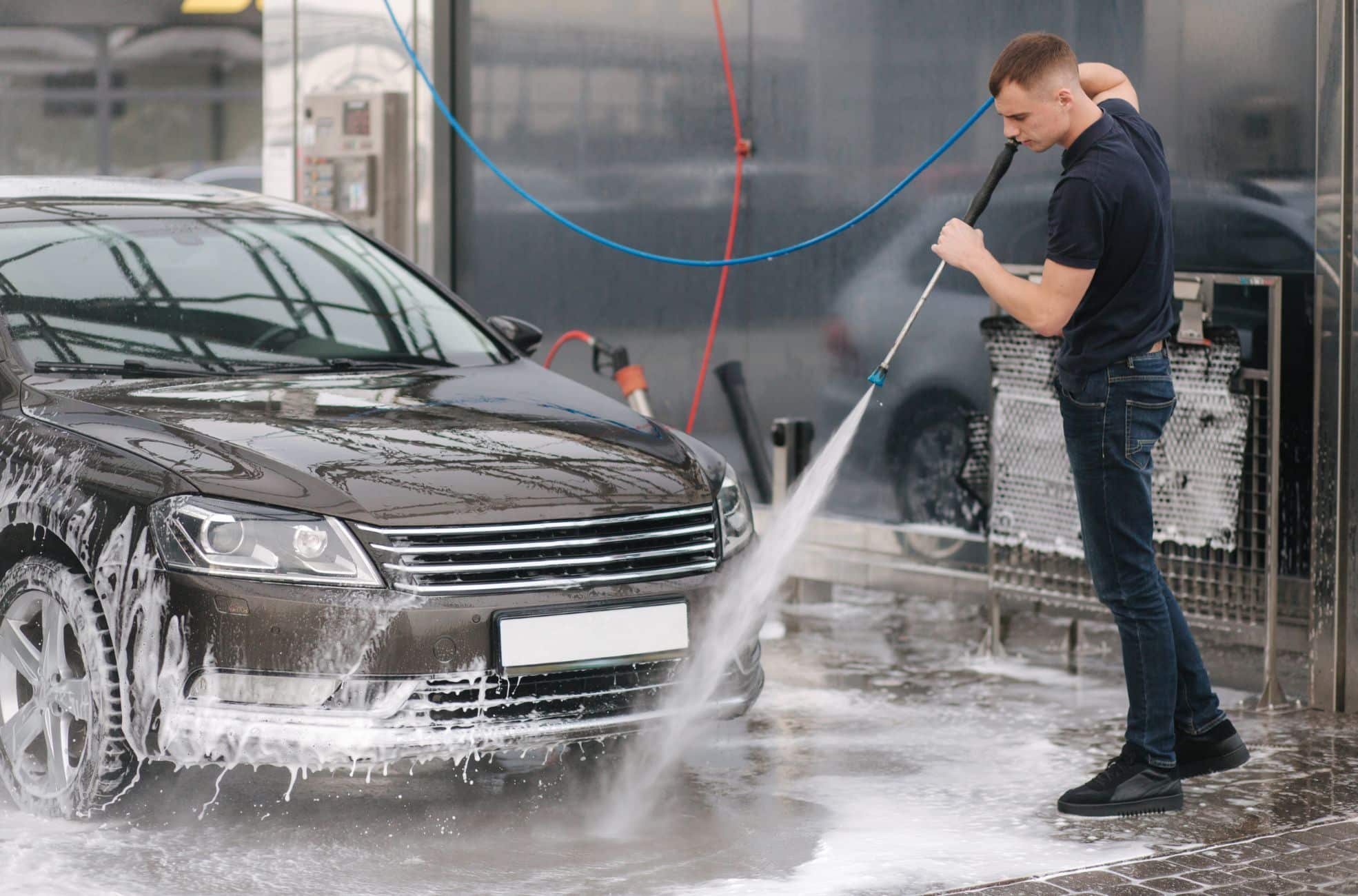 Man Using Hose For Car Wash