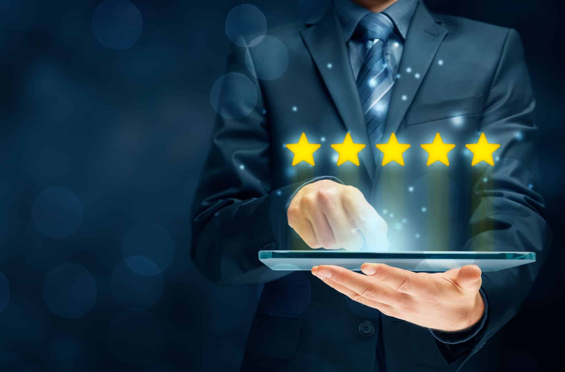 Man Giving 5 Star Review On Tablet