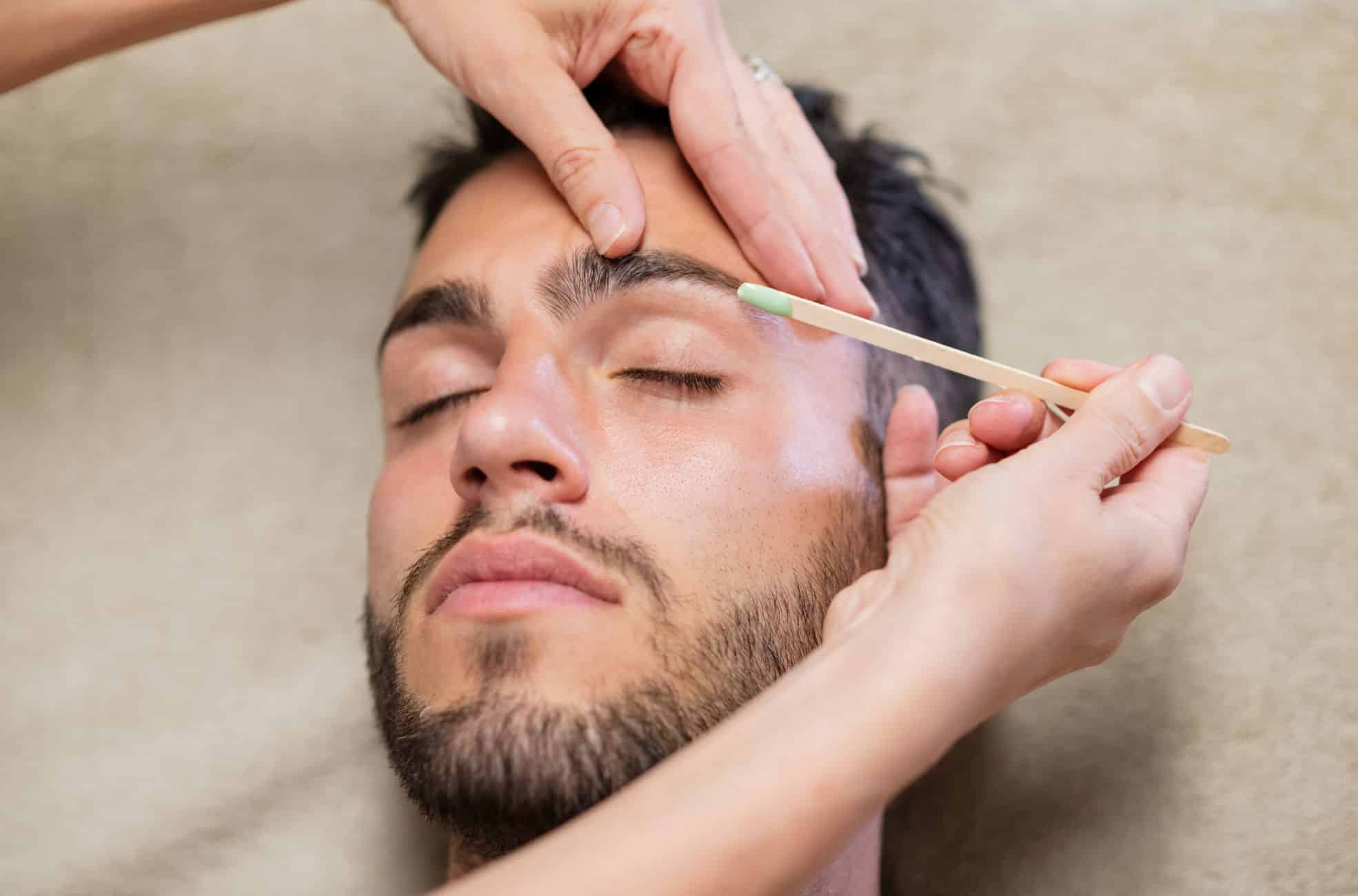 Man's Eyebrows Being Waxed
