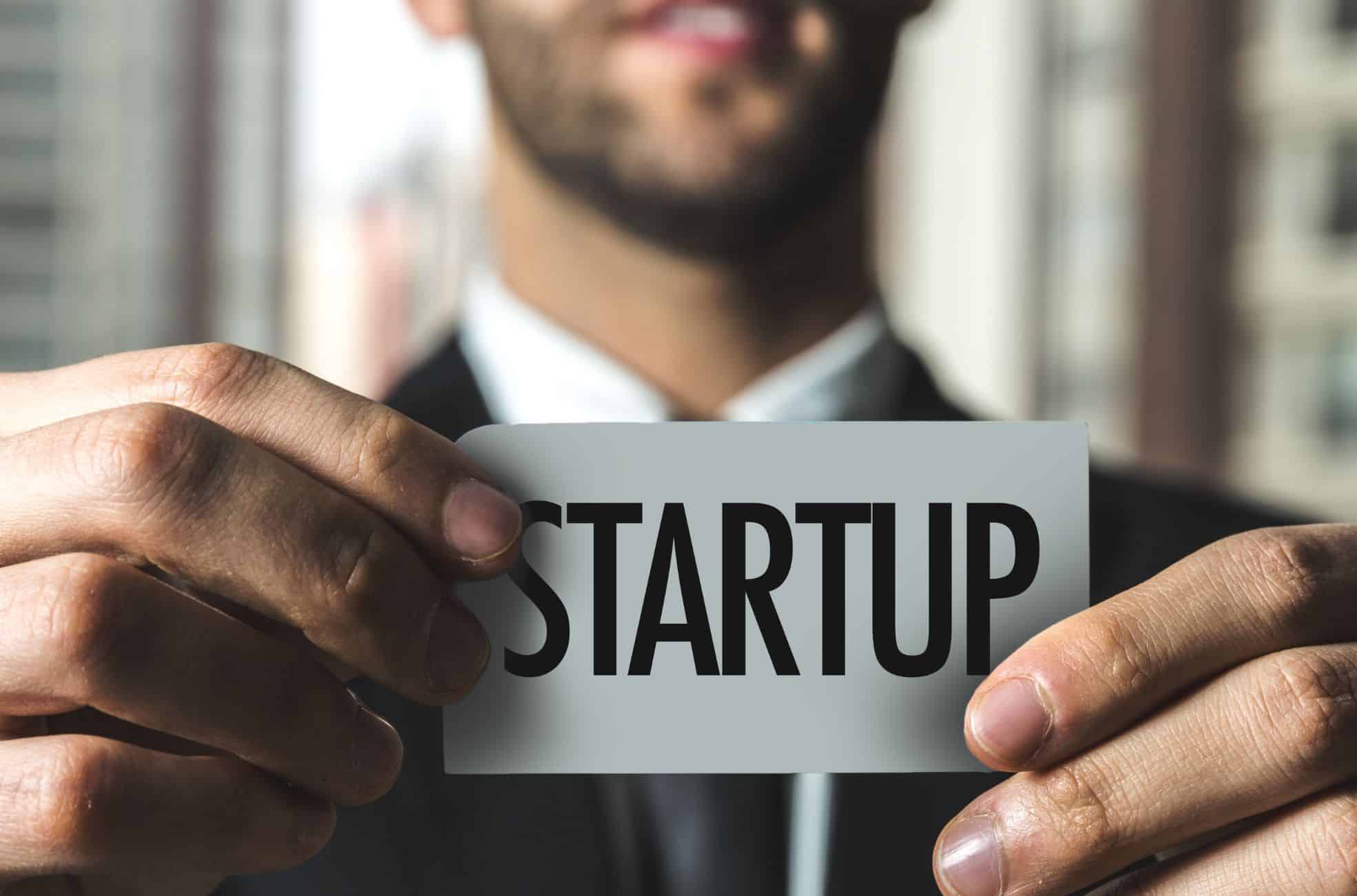 Man Holding Sign Saying "Startup"