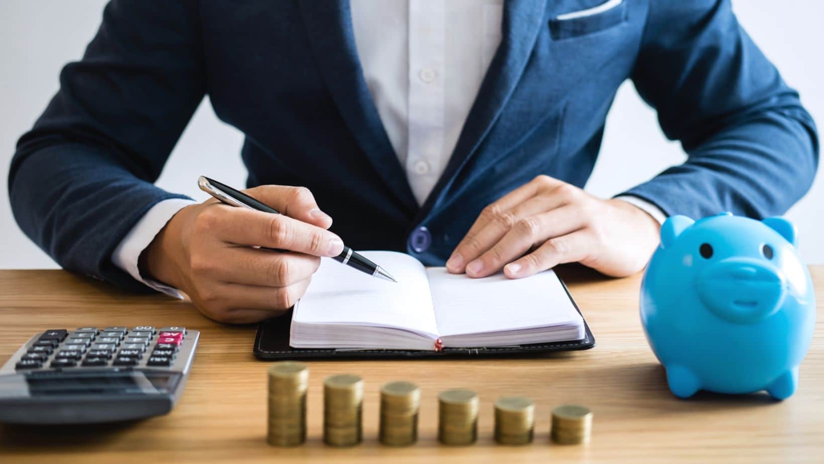 Man Counting Money At Desk